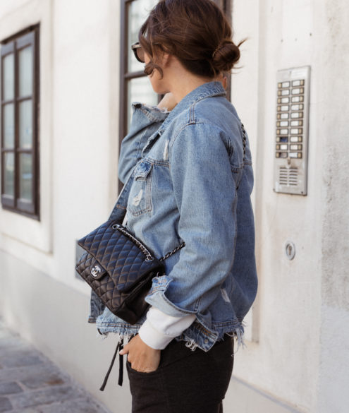 Woman with pale pink Chanel bag and black and white striped